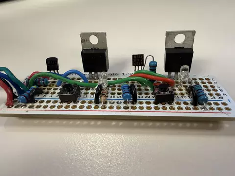 A circuit board showing two large power switching transistors