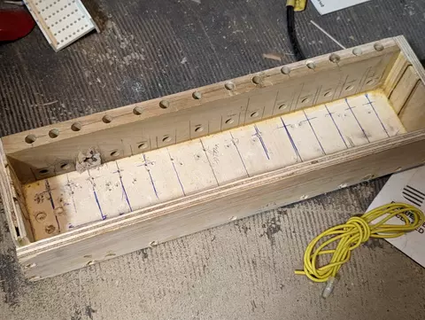 Wooden box with air holes for pipes