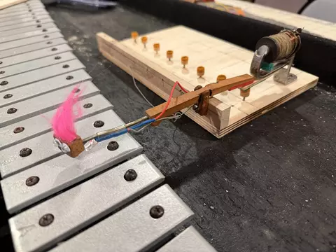 One hammer and actuator assembly in place over a bar