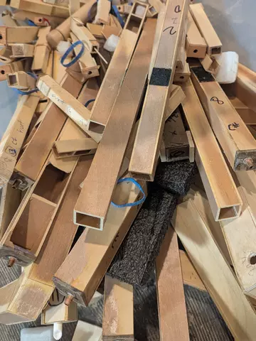 A pile of wooden organ pipes