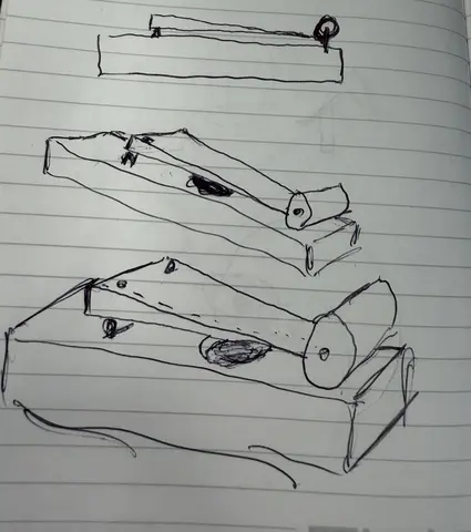 Pen sketch of wooden instrument concepts on lined paper.