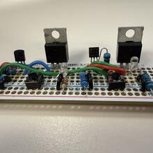 A circuit board showing two large power switching transistors